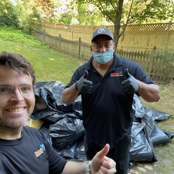 R1 Team hauling away wet carpet &amp; drywall!