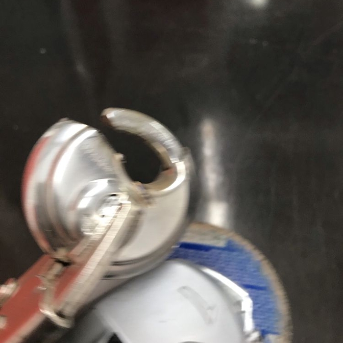 Cut a lock in a public storage warehouse.