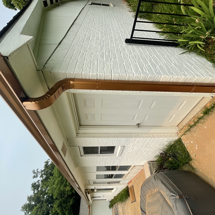 Front run of gutter with downspout