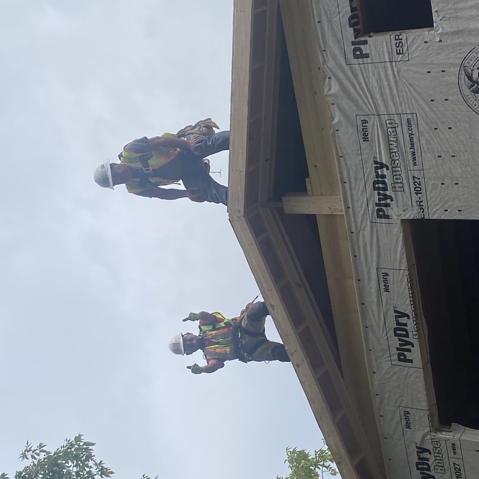 Team having a good time finishing roof.