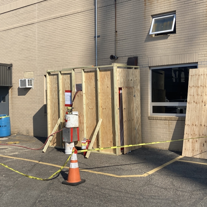 Asbestos pipe removal with outside decon unit.