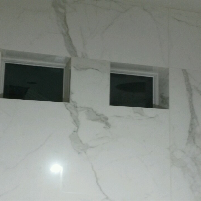 Port windows wrapped with large format porcelain t