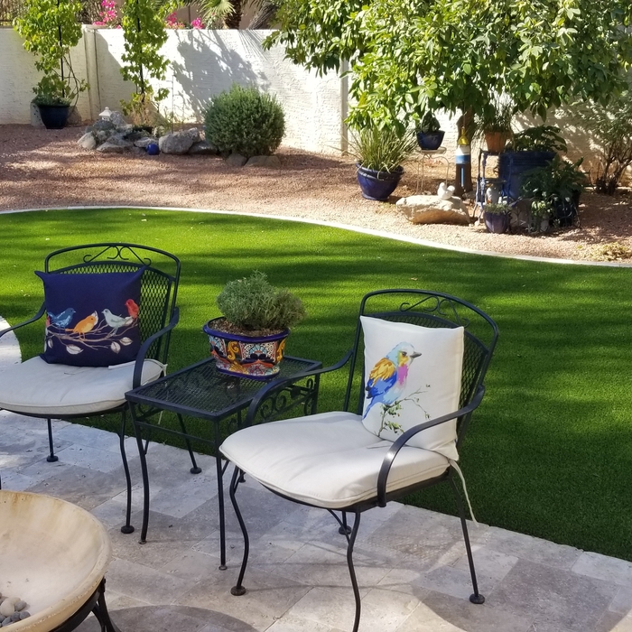 A beautiful look with Travertine and syn. grass.