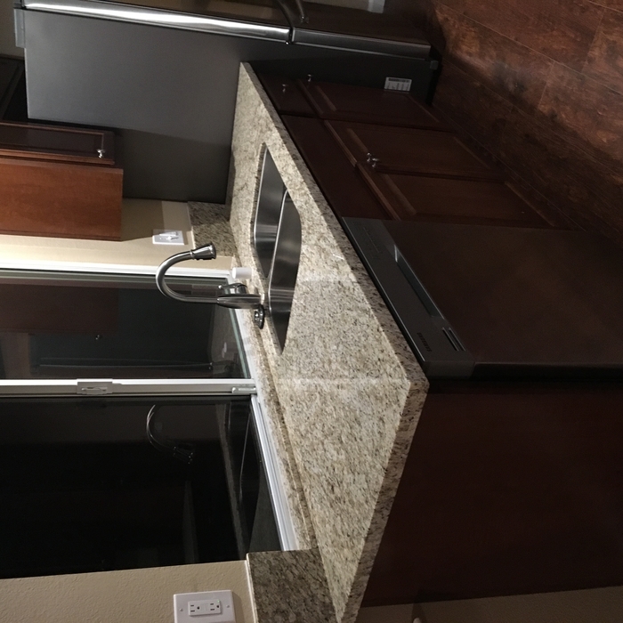 Sink with granite countertop and window sill.
