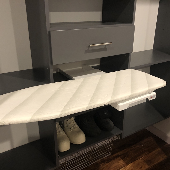 Hide away ironing board that folds out.